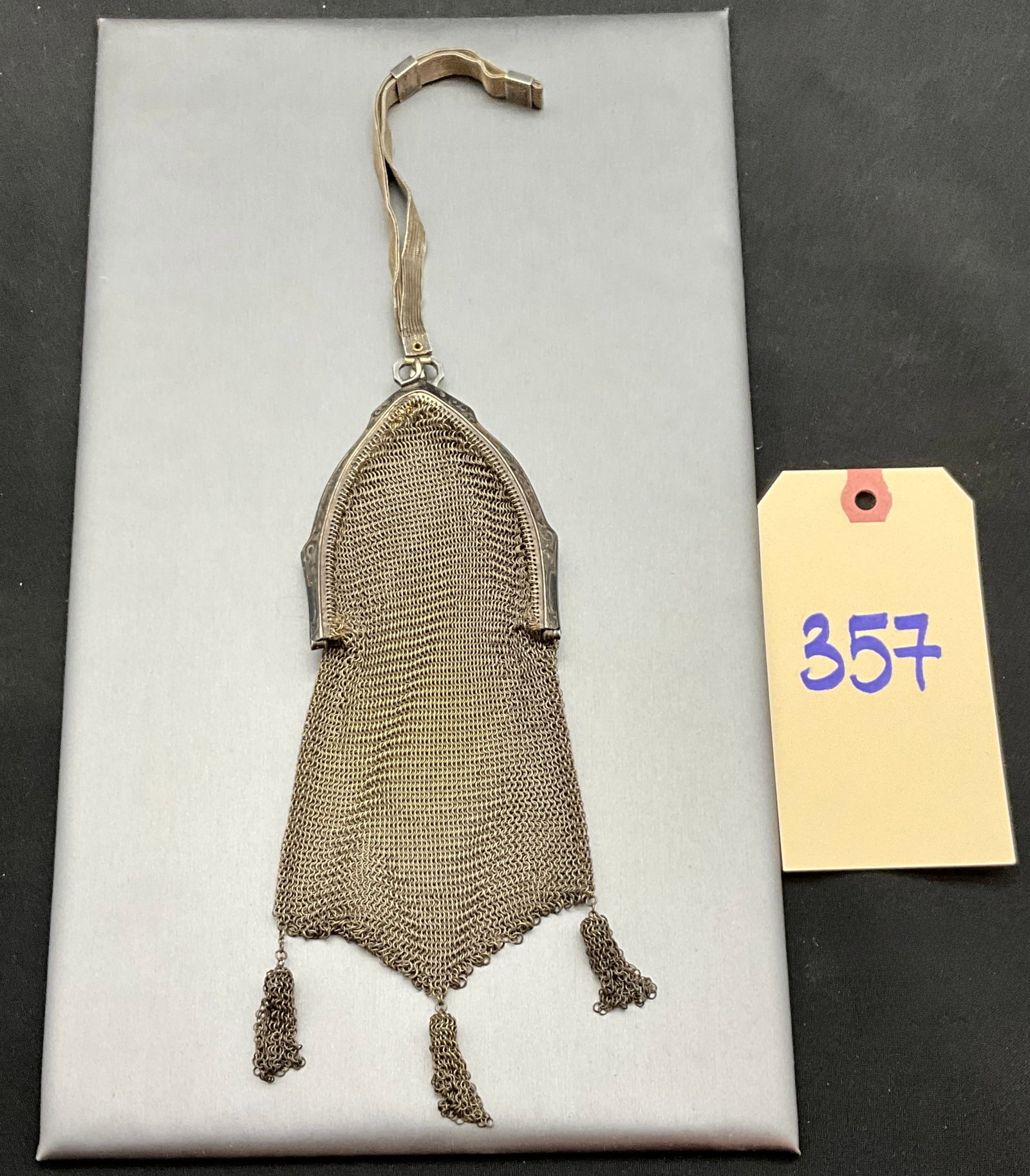Antique Art Deco Style Silver Mesh Wristlet Purse: This antique silver mesh wristlet purse features a fine-gauge link body with an engraved pointed frame and terminates in three mesh tassels. A coordinating flat mesh wrist strap is attached via a