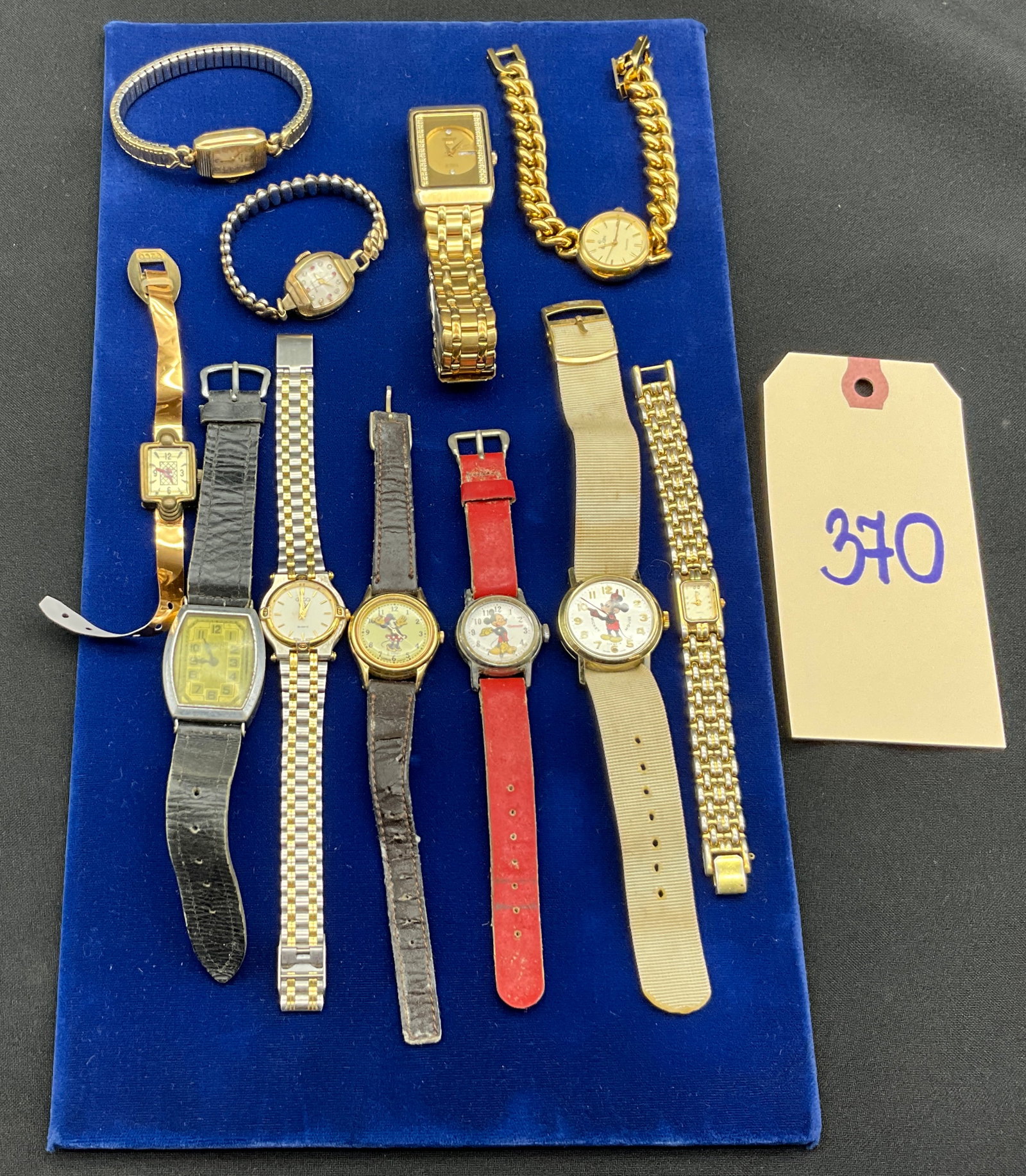 A Collection of Eleven Vintage and Modern Metal Wristwatches: This collection features eleven assorted vintage and modern wristwatches in character, dress, and fashion styles, including Disney licensed models by Bradley, Ingersoll, and Lorus alongside