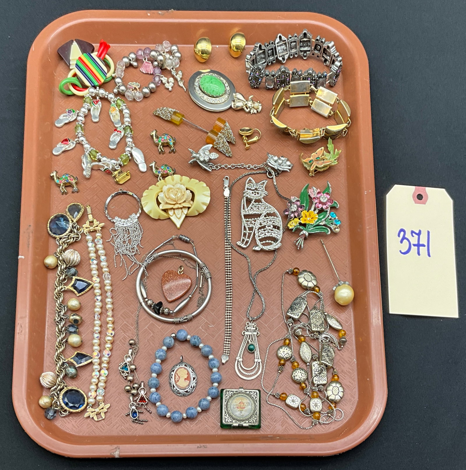 Vintage Assorted Style Mixed Material A Collection of Costume Jewelry, as-is: This lot features a variety of vintage and contemporary costume jewelry and a religious artifact including necklaces, bracelets, and figural pins in assorted metals and plastics. Notable items include