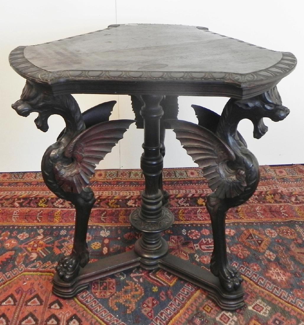 GOTHIC GRIFFIN STAND: GOTHIC SYLE THREE LEGGED WALNUT STAND WITH THREE GRIFFINS HOLDING UP THE TABLE TOP. MEASURES 30"H X26"W