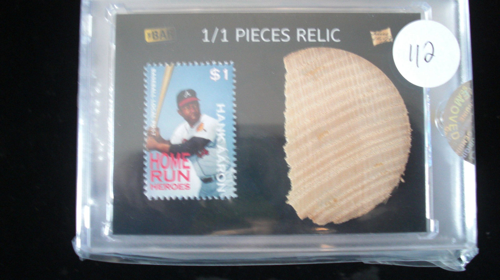 the bar 1/1 hank aaron stamp and bat relic: in hard plastic case