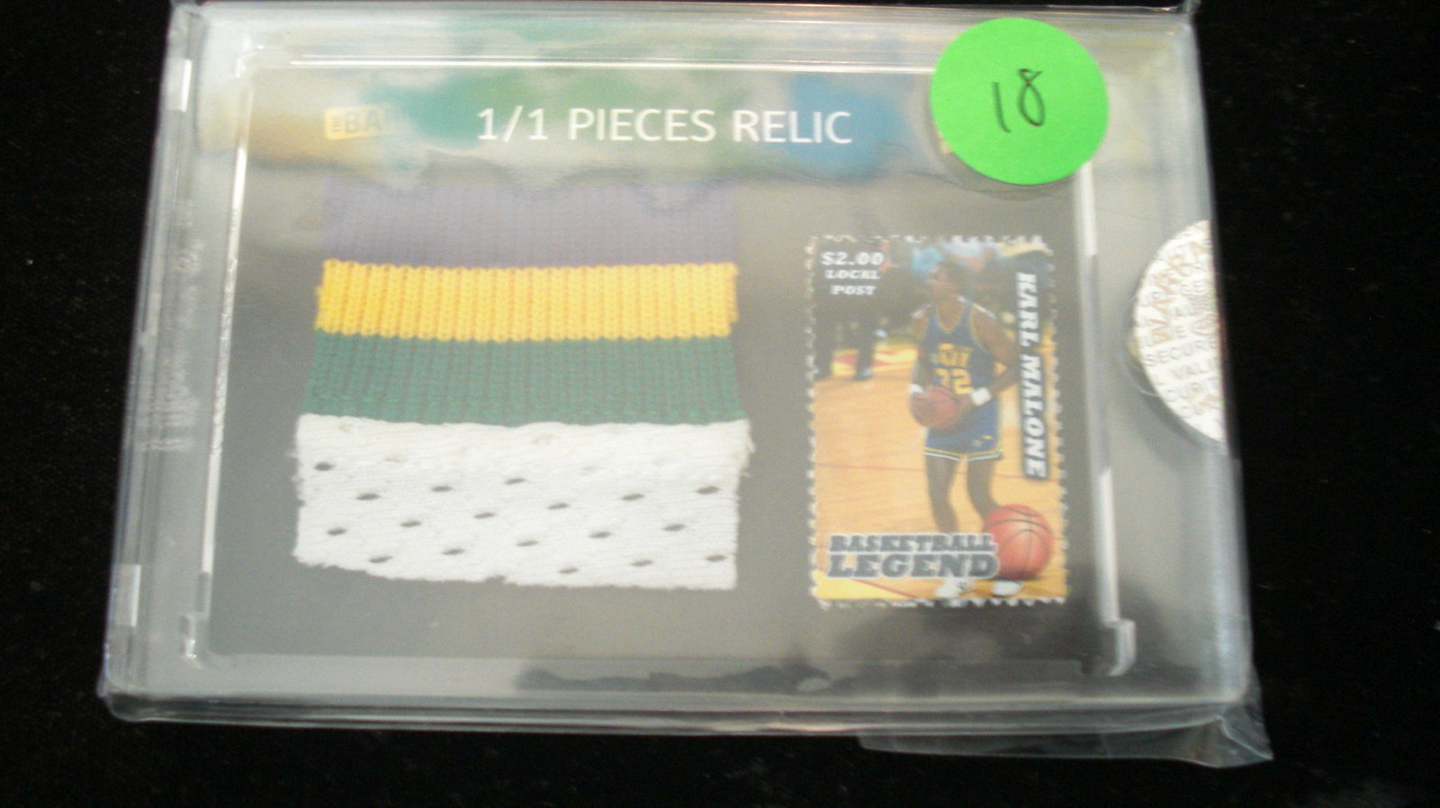 the bar 1/1 karl malone stamp and relic: in hard plastic case