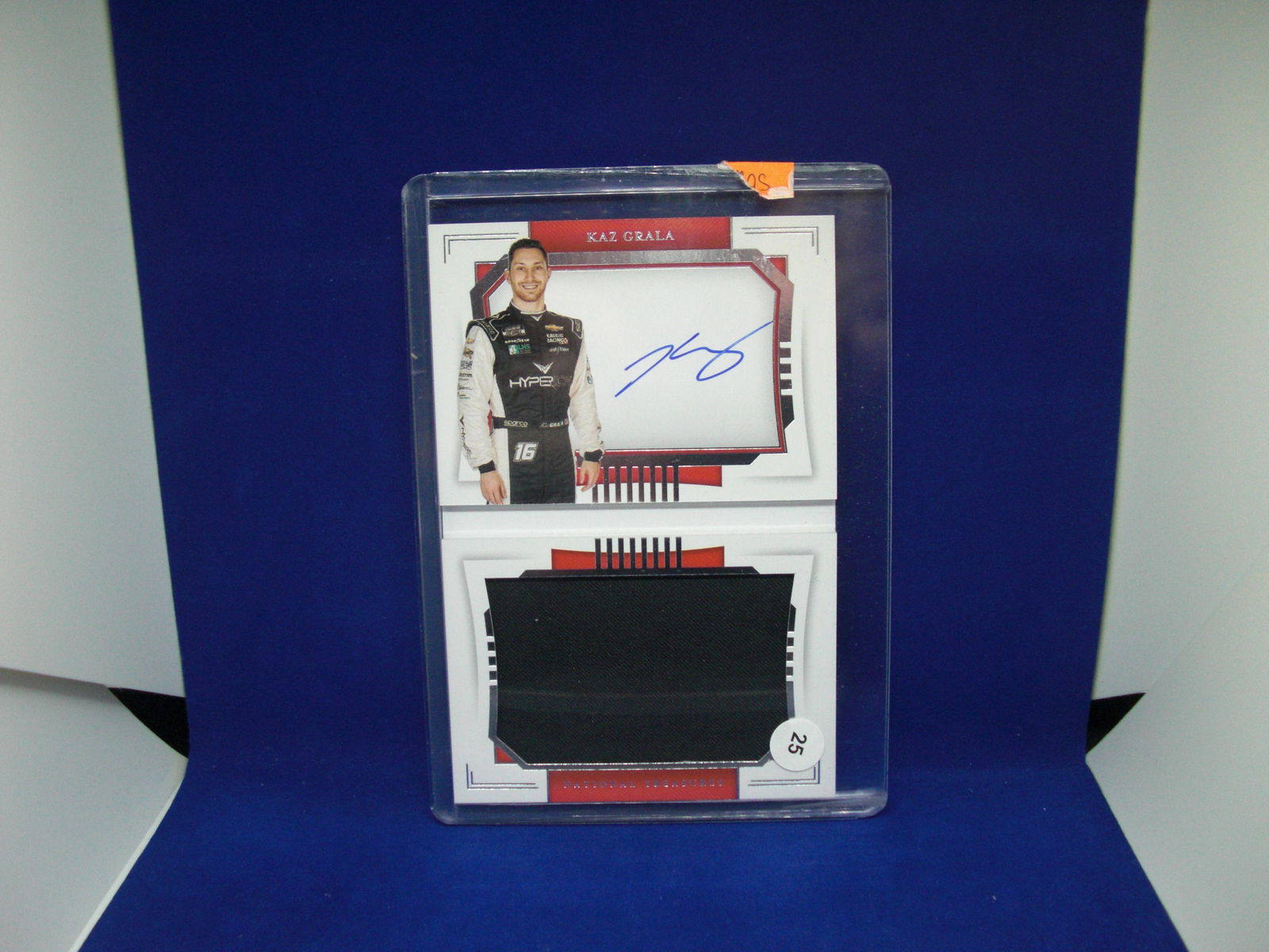 KAZ GRALA NATL TREASURES FIRE SUIT RELIC BOOKLET 18/25 (1 of 1)