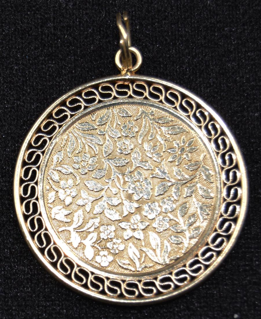 14k Yellow Gold Circular Pendant: Floral and leaf decorated center with open work border; 1 1/4" dia.; approx. 6.5 grams