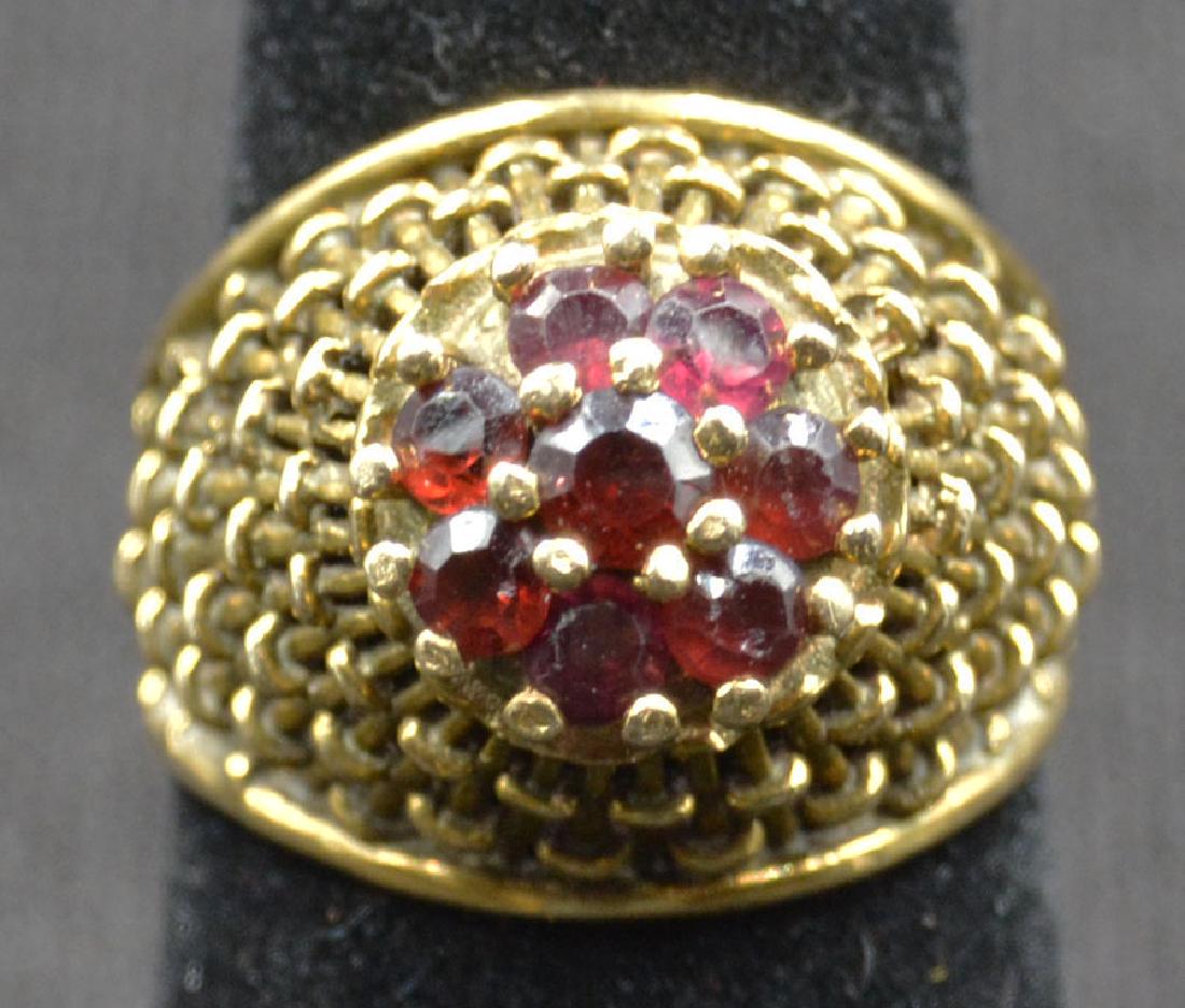 14k Yellow Gold and Garnet Ring: Open work basket weave setting; having 8- round garnets being approx. .64 carats total weight; size 7 1/2; 7.4g total weight