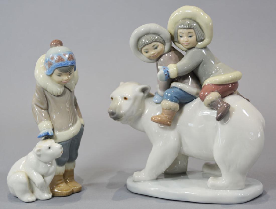 Two Lladro Eskimo Figurines: Boy standing next to cub, 5 1/2" high and boy and girl riding on a Polar Bear, 6 3/4" high.