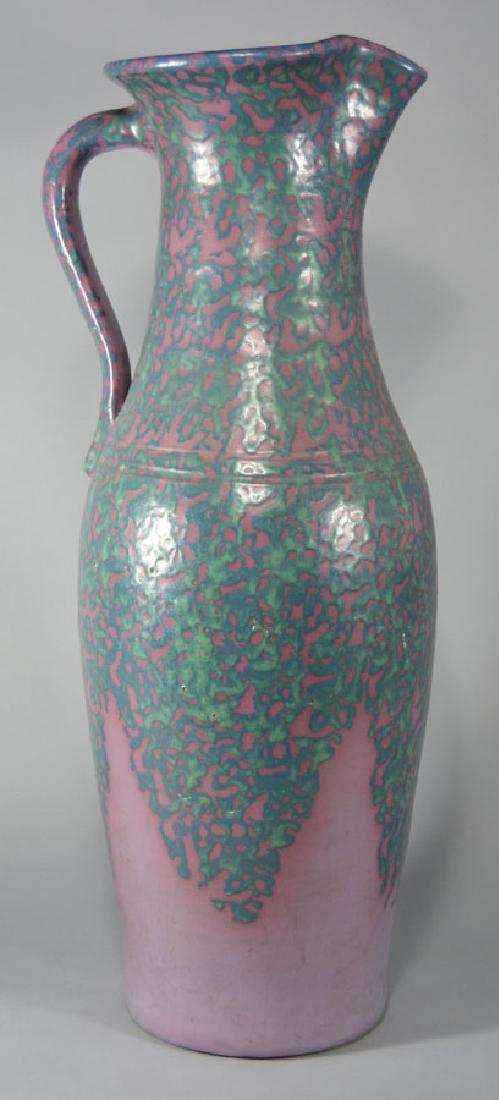 American Art Pottery Ewer: early 20th Century, waisted neck over a shouldered tapering body, handled, having lavender and turquoise decorated glaze throughout, 26 3/4" high.