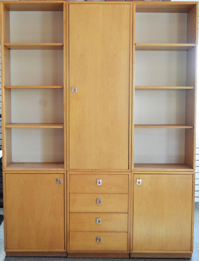 Six-Piece Jack Cartwright Founders Modular Wall Unit: Maple veneer throughout, having a central cabinet with one door (#25441) over a lower cabinet with 4-drawers (#25436), flanked on each side by open bookcases (#25440) each over a cabinet with a single