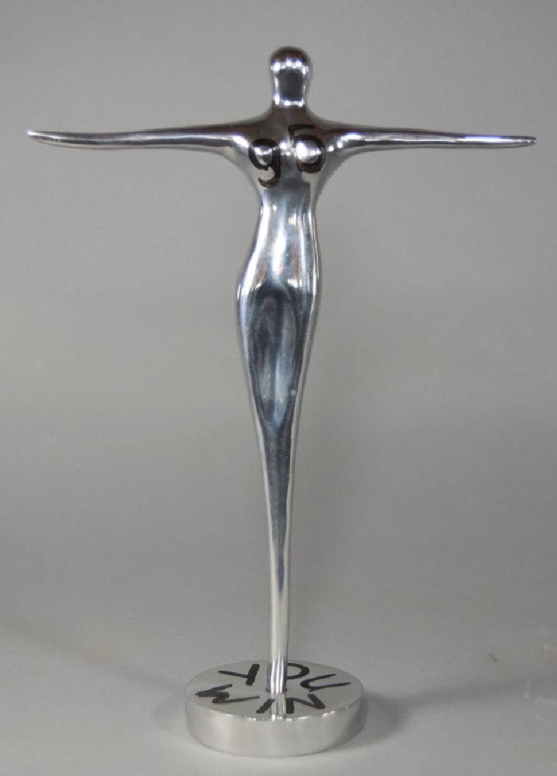 Mid-Century Chromed Figure: Cast aluminum female figure with outstretched arms, on a circular base, 13" tall.