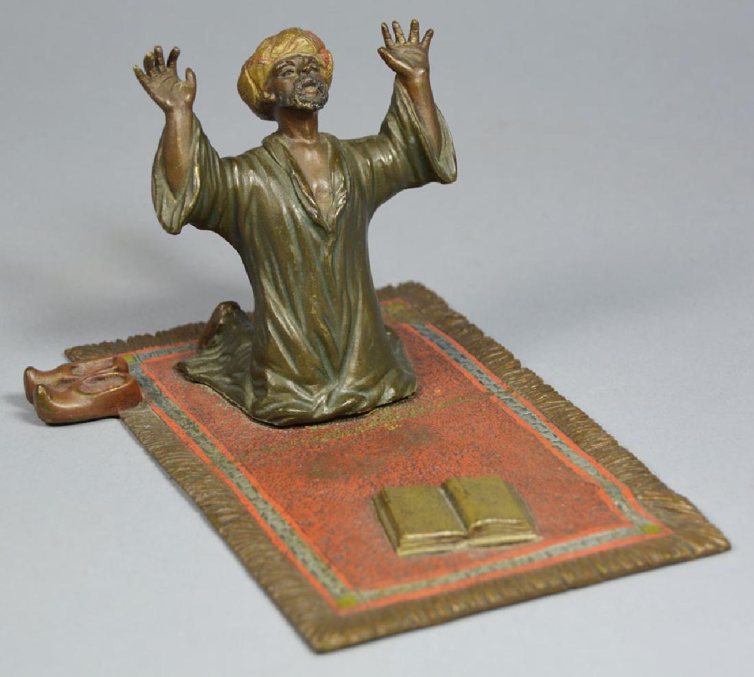 Antique Austrian Cast Bronze Figure: late 19th/early 20th C., depicting a man kneeling on a rug praying with a book, cold painted, 6" long, 3 3/4" deep, 3 1/4" high.