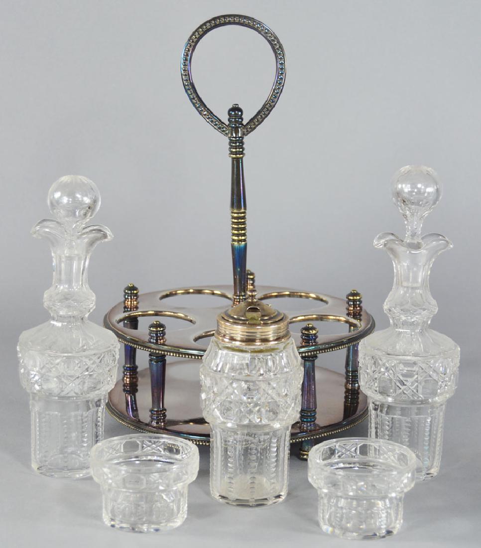 Christofle and Crystal Condiment Set: Comprising oil and vinegar bottles, a covered condiment with an 800 silver top, and two open condiments, on a silver-plated stand, 7" diameter, 10 1/2" high..
