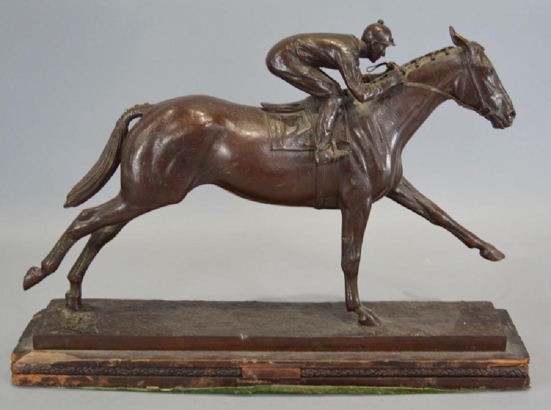 Marilyn Newmark (1928-2013): Bronze sculpture, "Man O' War", depicting a running race horse and jockey, raised on a wooden base, signed and dated 1977 on the plinth, 9" high, 14" long.