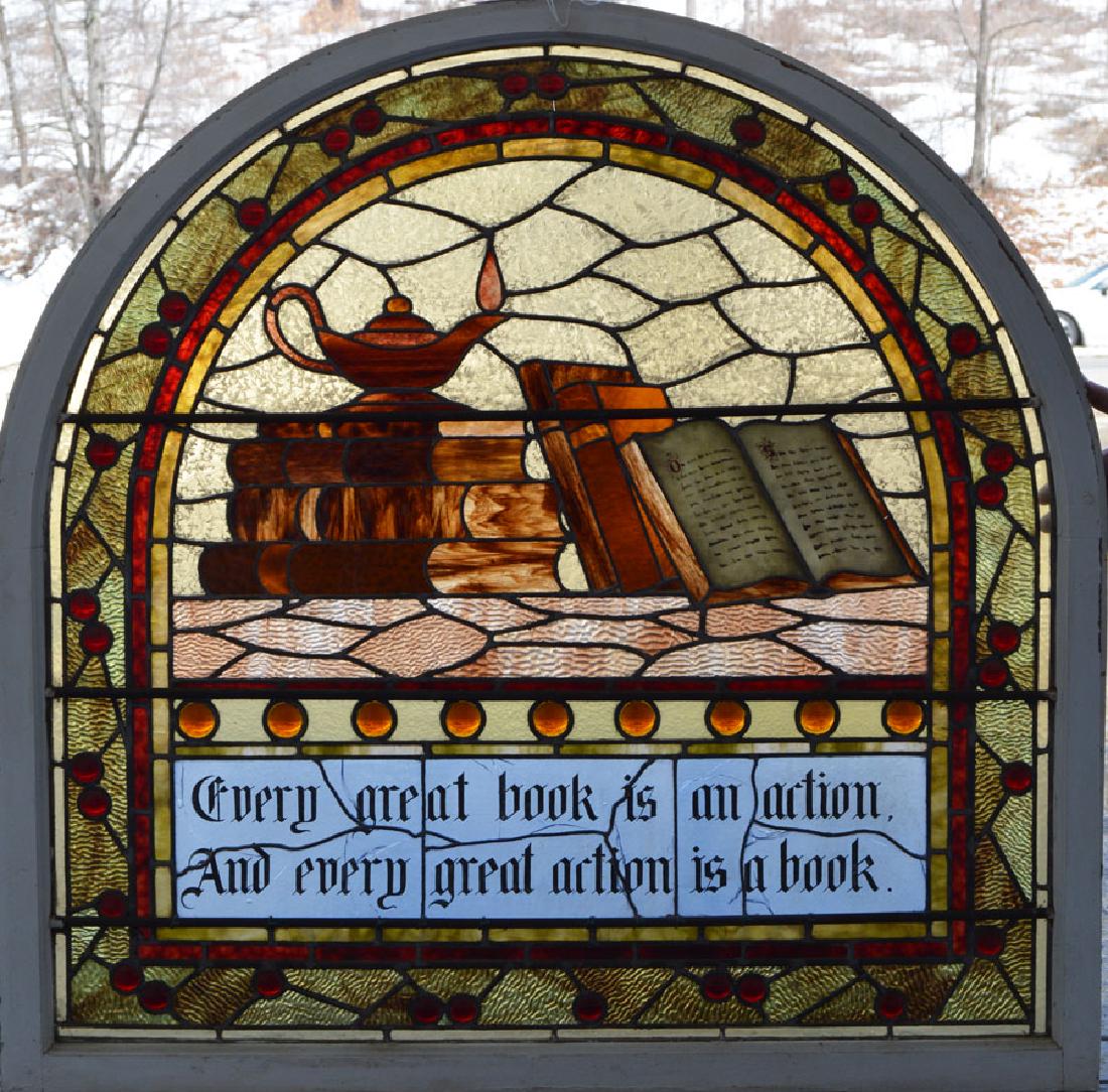 19th C. Archtectural Stained Glass Window: arched top, being related to Literature depicting books and an oil lamp, with the bottom panels bearing the inscription "Every great book is an action and every great action is a book", 36 3/4" wide, 