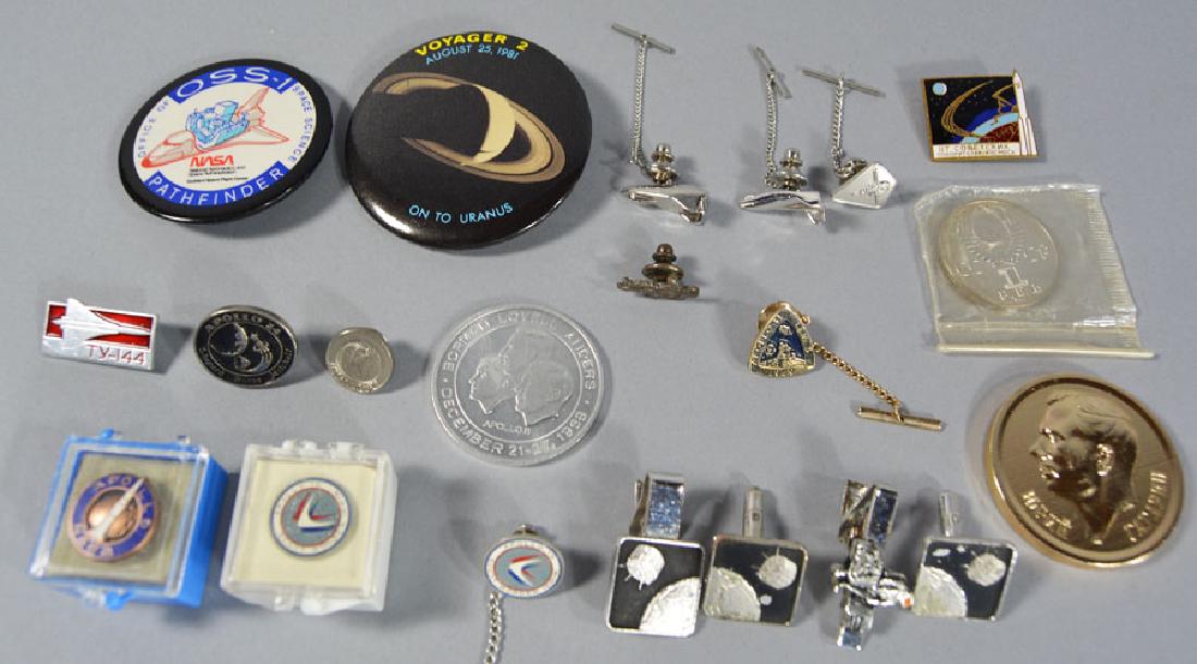 Twenty-One Space Related Items: Comprising 3-Coins, being an Apollo 8 "First Lunar Apollo Flight, a Russian coin commemorating the First woman cosmonaut in space and a larger Russian coin, along with 18- clothing related NASA items 
