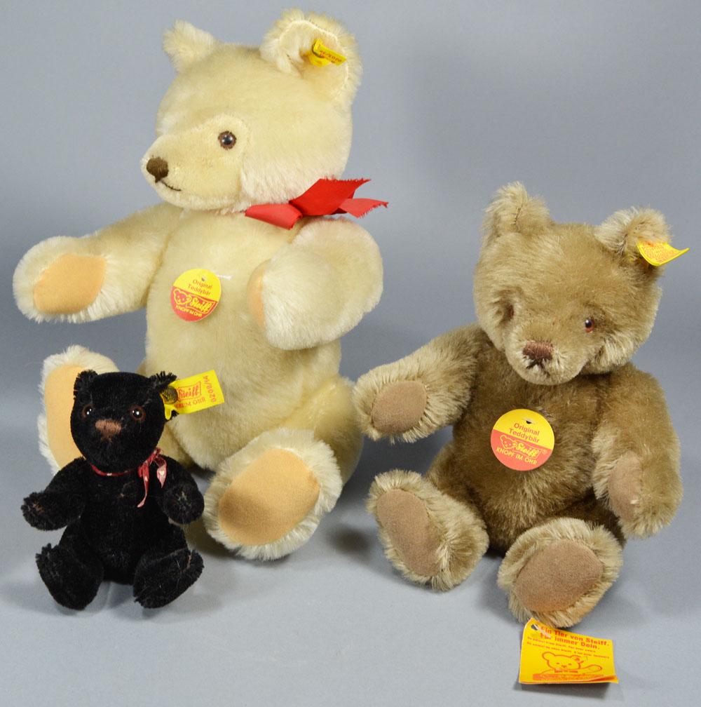 Three Steiff Teddy Bears: all jointed, comprising 0203/36 light tan with Red Bow, 12", 0208/14 small black, 5" H., and 0202/26 caramel, 9" H.