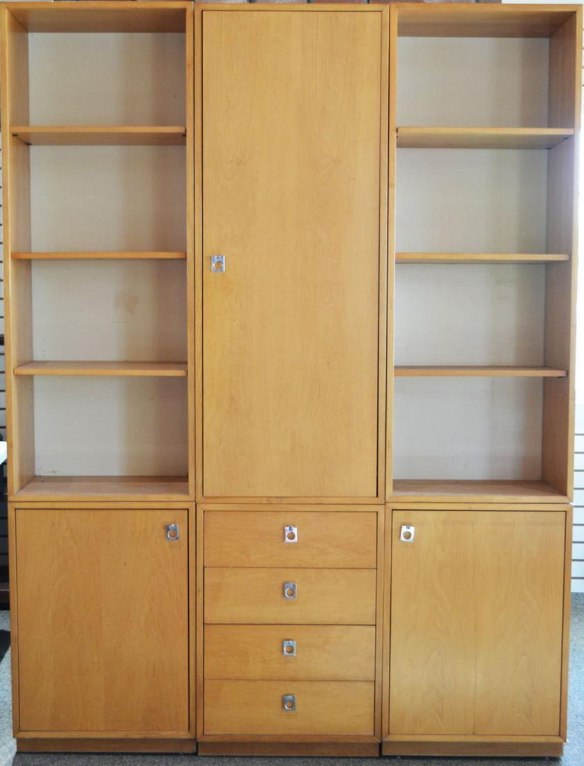 Six-Piece Jack Cartwright Founders Modular Wall Unit: Maple veneer throughout, having a central cabinet with one door (#25441) over a lower cabinet with 4-drawers (#25436), flanked on each side by open bookcases (#25440) each over a cabinet with a single