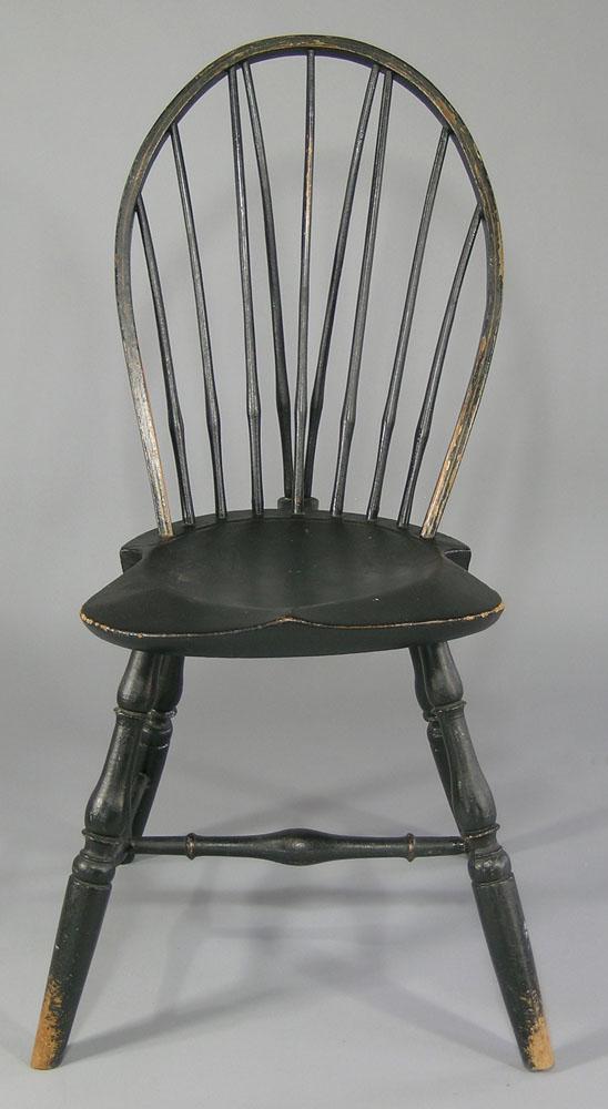 Antique New England Braced Bow-Back Windsor Chair: late 18th/Early 19th C., black paint with gilt line highlights on bow back, seven spindles, saddle seat, 37" to top of bow back, 17" seat height.
