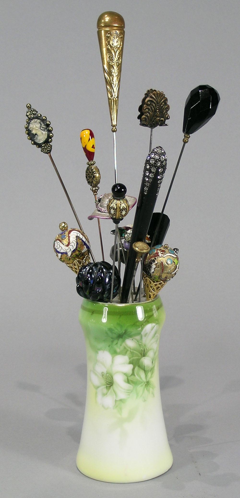 Collection of 17 Vintage and Modern Hat Pins: various designs and lengths including enameled, brass and silver, all in a hand painted RS Germany Porcelain Hat Pin holder, 4 5/8" high.