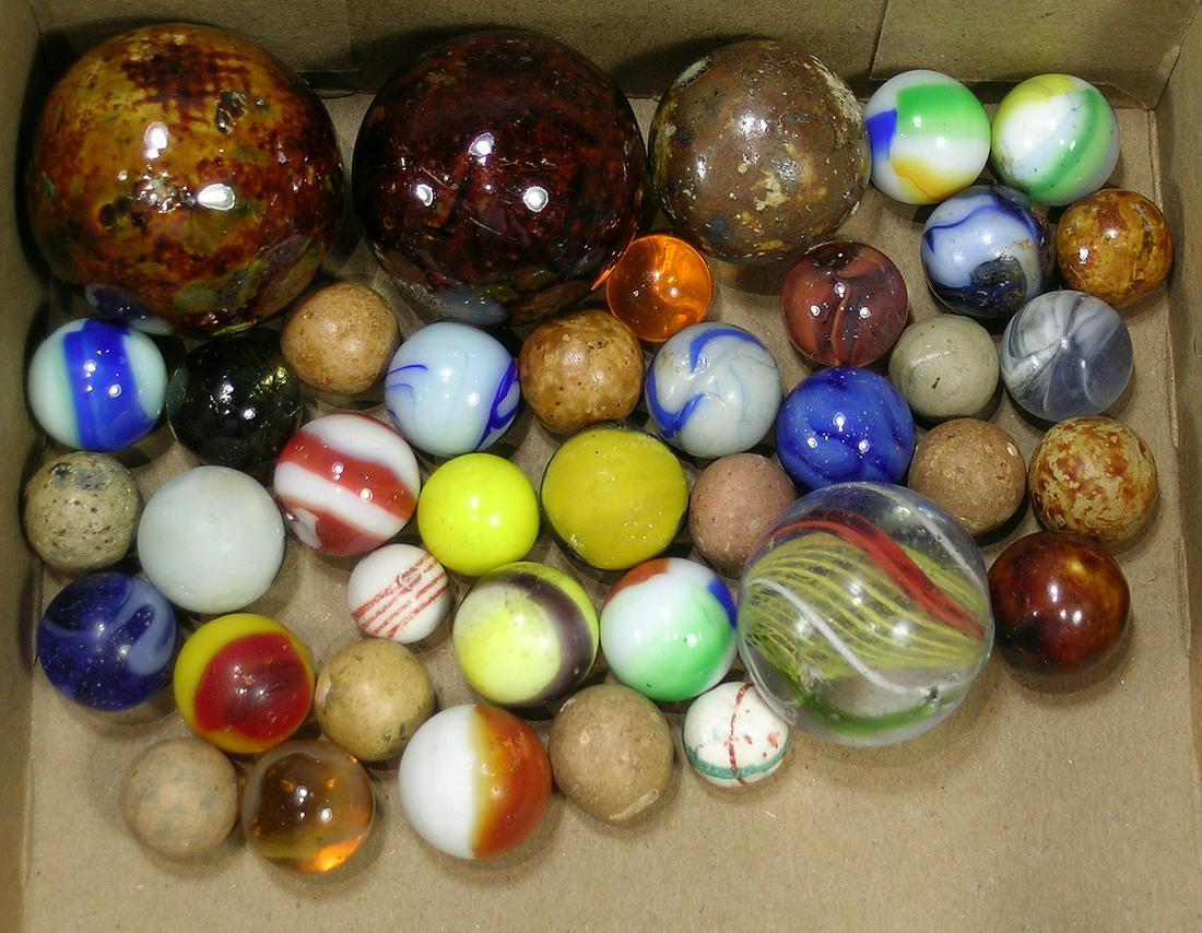 Thirty-Nine Antique and Vintage Marbles: Bennington, clay, mini-ceramic, glass, etc., the smallest being 1/2" dia., the largest being 1 1/2" dia.