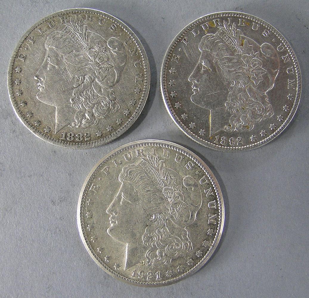 Three Morgan Silver Dollars: 1882-O, 1892, 1921-S