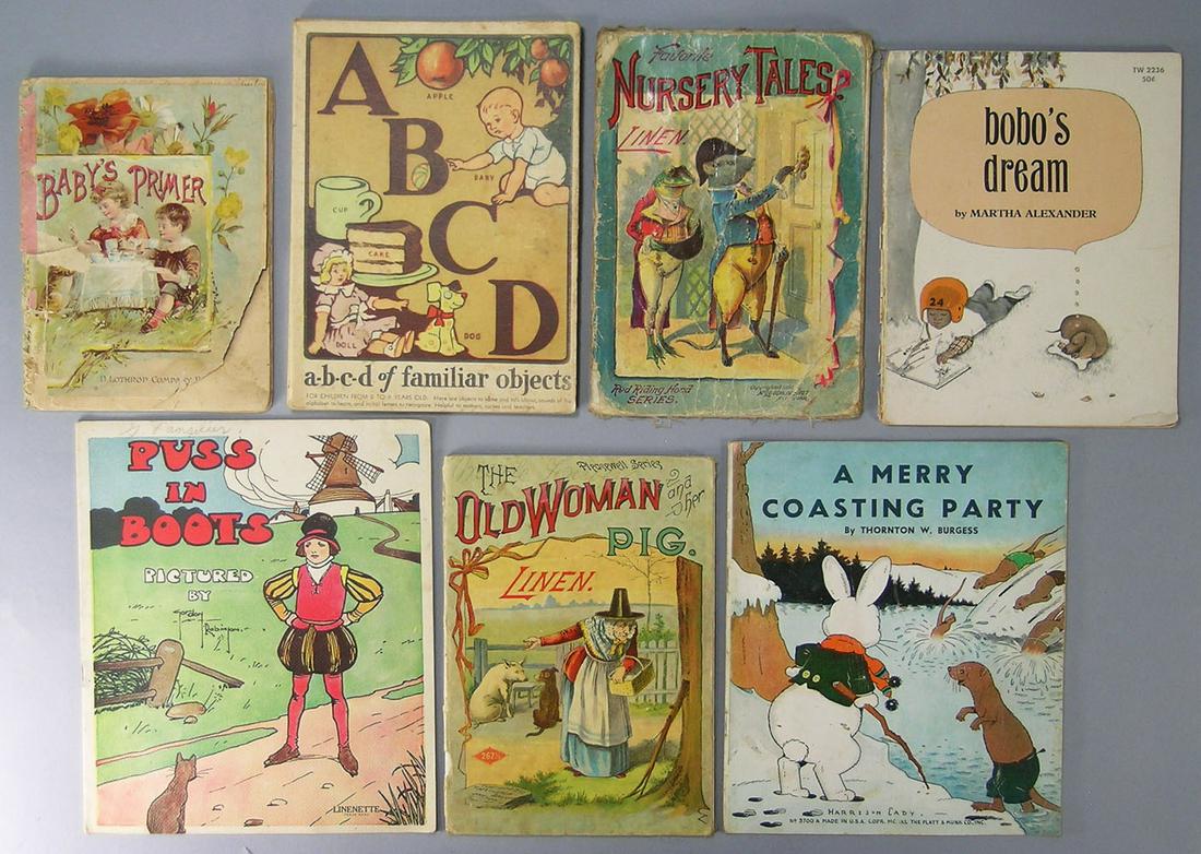 Seven Late 19th/Early 20th C. Children's Books, etc.: comprising Baby's Primer 1885, A-B-C-D Of Familiar Objects, Favorite Nursery Tales, The Old Woman And Her Pig on linen, A Merry Coasting Party, Puss In Boots and Bobo's Dream
