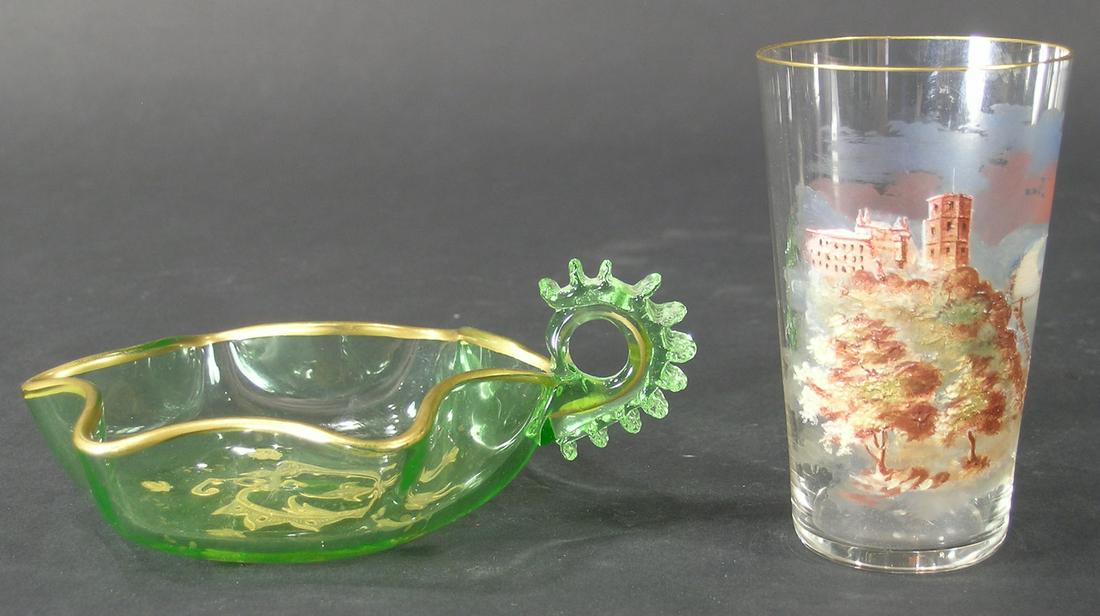 TWO MOSER STYLE TABLE ARTICLES: comprising a nappy, having a gilt rim, scrolling leaf and roses decoration, 5 1/4" long, and a juice glass, having a landscape decoration with castle and river, gilt rim, 2 1/8" dia., 3 3/4" high