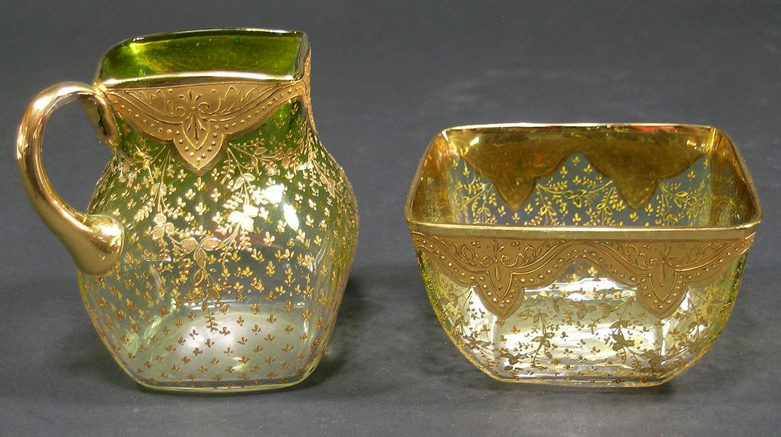 MOSER GLASS SUGAR BOWL AND CREAMER: square in shape, light green glass shading down to clear, having overall gilt floral, leaf and drape decoration, sugar bowl being 3 3/4" sq., 2 1/4" high, creamer being 3" sq., 3 7/8" high