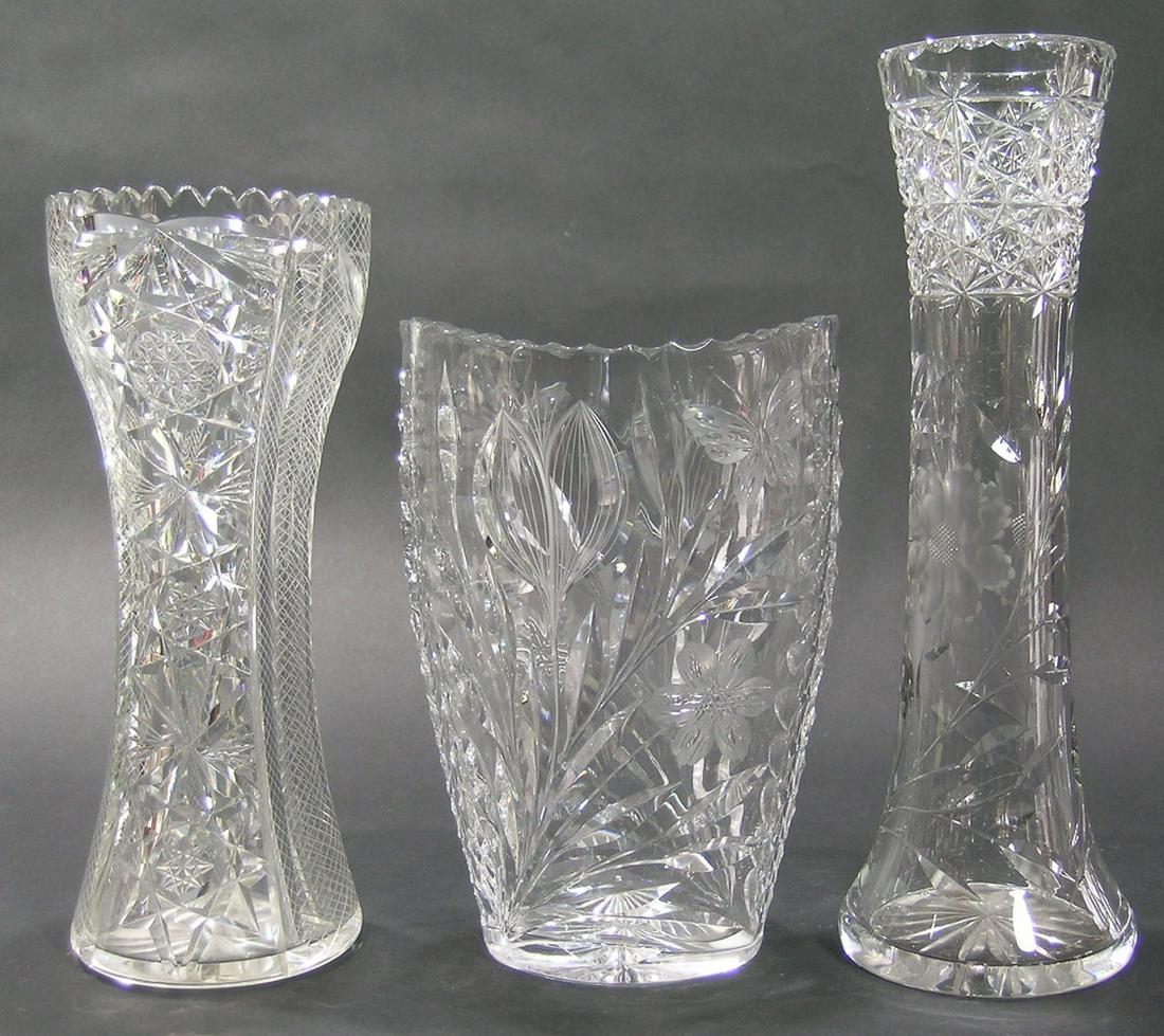 THREE PAIRPOINT CUT GLASS VASES: two wasted in form, one decorated in the Viscaria pattern, 4" dia., 11 3/4" high and one having button, vine with leaves on a cross hatch pattern, 4 1/4" dia., 10" high, and one tapering oval form in 