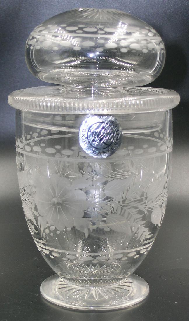 GUNDERSEN PAIRPOINT ETCHED GLASS FOOTED COVERED URN: having etched floral and leaf decoration, cut rim, 6 1/4" high, having a Gundersen Masterpiece label on side.