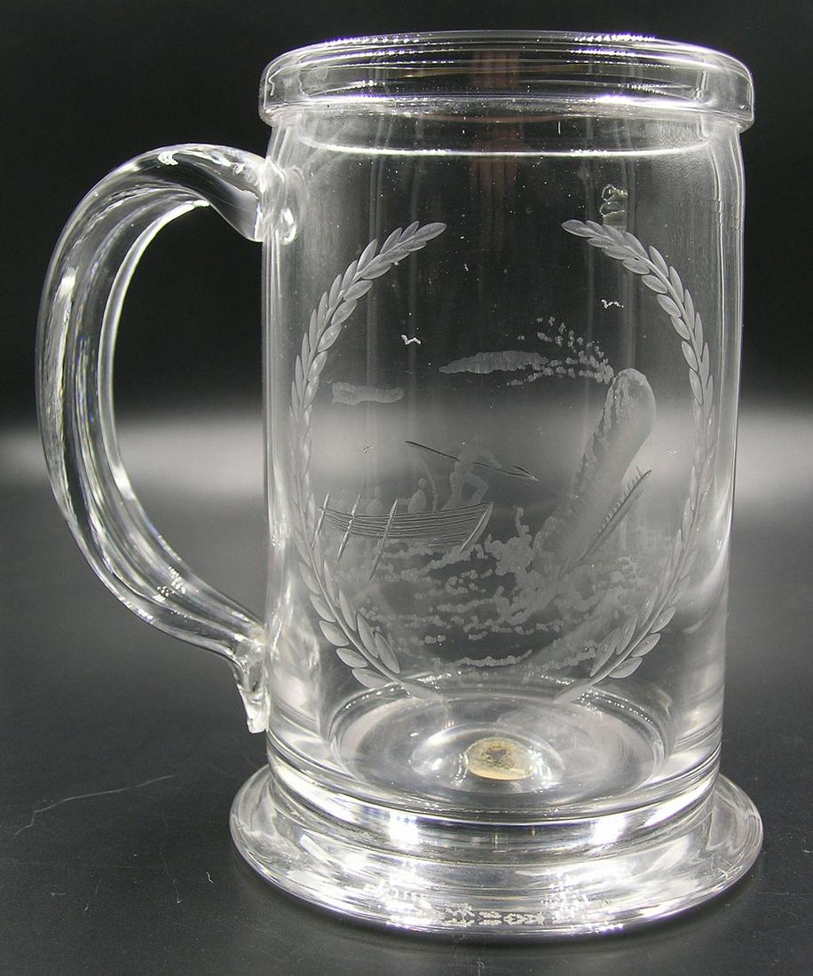 POAIRPOINT ETCHED GLASS MUG: having an etched whaling scene surrounded by a wreath, 5 3/4" high, also having a Pairpoint paper label along with Bryant Silvia etched to underside of base