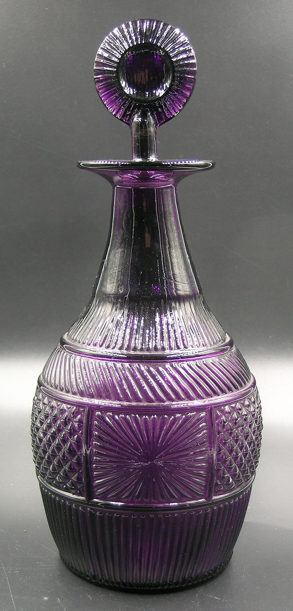 SANDWICH GLASS MOLD-BLOWN DECANTER: Amethyst glass, having varying panels of cross hatch and sunburst decoration, 10 1/2" to top of stopper