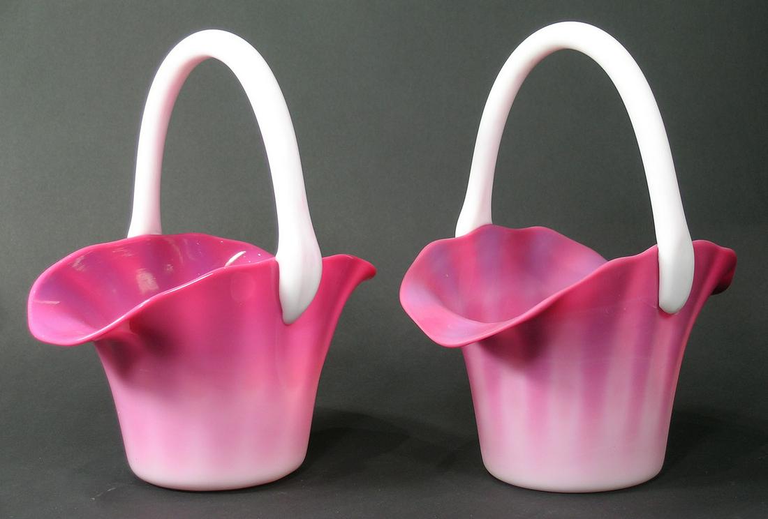 TWO MT. WASHINGTON GLASS PEACHBLOW BASKETS: with white handles, one matte finish, one glossy finish, both being approx. 8" long, 5" wide, 10" high and having polished pontils. Provenance: Matte finish basket formerly from the F. and P. Rindge C
