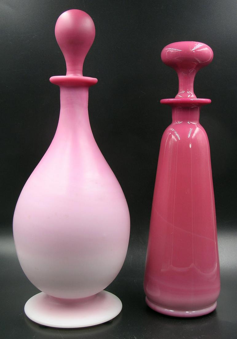 TWO GUNDERSEN PAIRPOINT GLASS BOTTLES WITH STOPPERS: one being a perfume bottle, glossy finish in flaring form with mushroom shaped stopper, 10 3/4" high, and one being a decanter, matte finish in footed bulbous form, 11 3/4" high, both having polished 