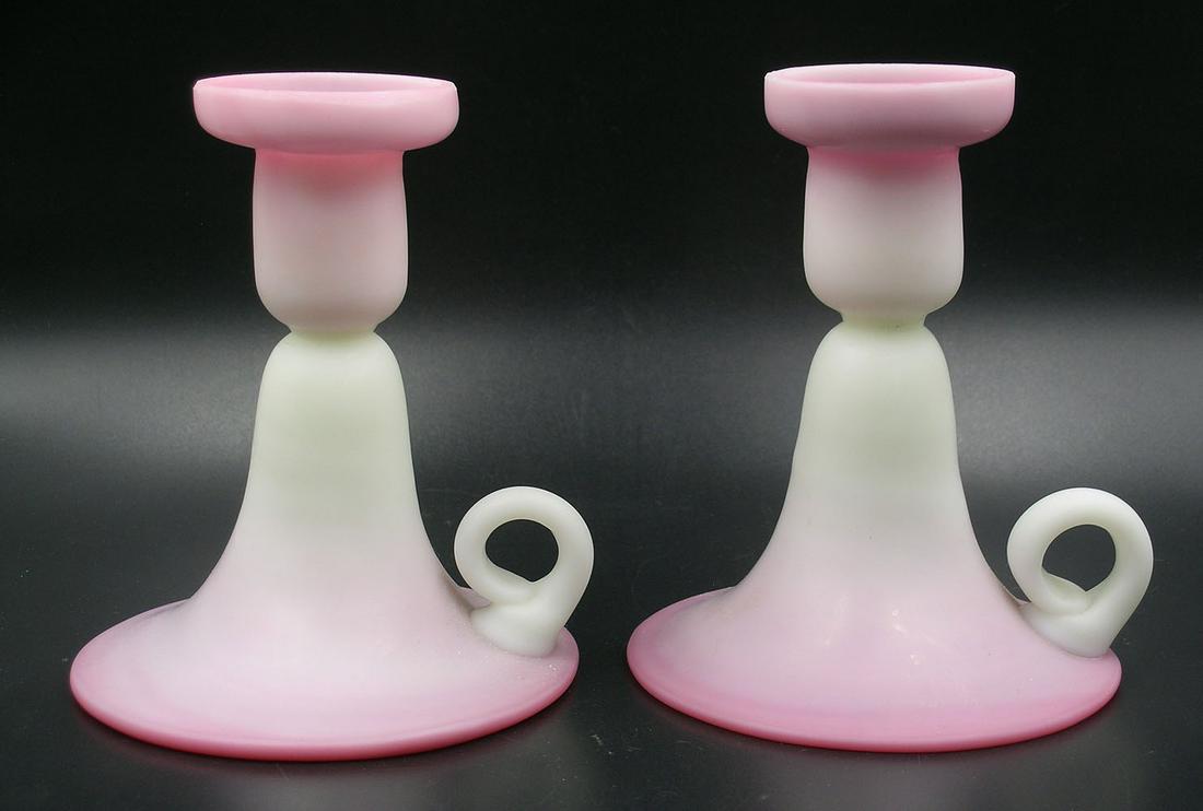 TWO PEACHBLOW GLASS FINGER CANDLESTICKS: both matte finish, 4" dia., 5" high Provenance: Both formerly from the F. and P. Rindge Collection