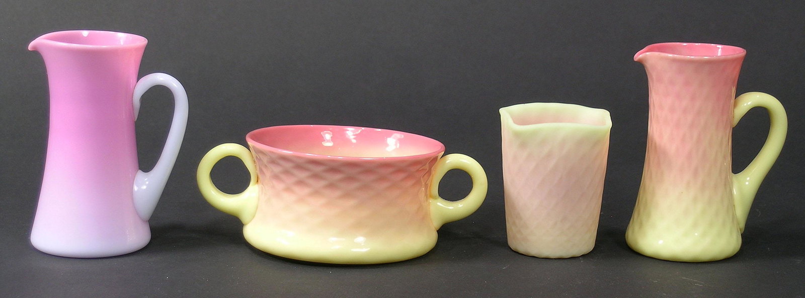 FOUR MT. WASHINGTON GLASS TABLE ARTICLES: comprising a Peachblow creamer, 3 3/4" high, and a Burmese creamer, sugar bowl and toothpick holder all having Diamond Quilted design, creamer 3 3/4" high, sugar bowl, 2" high, toothpick holder 2 1/2"