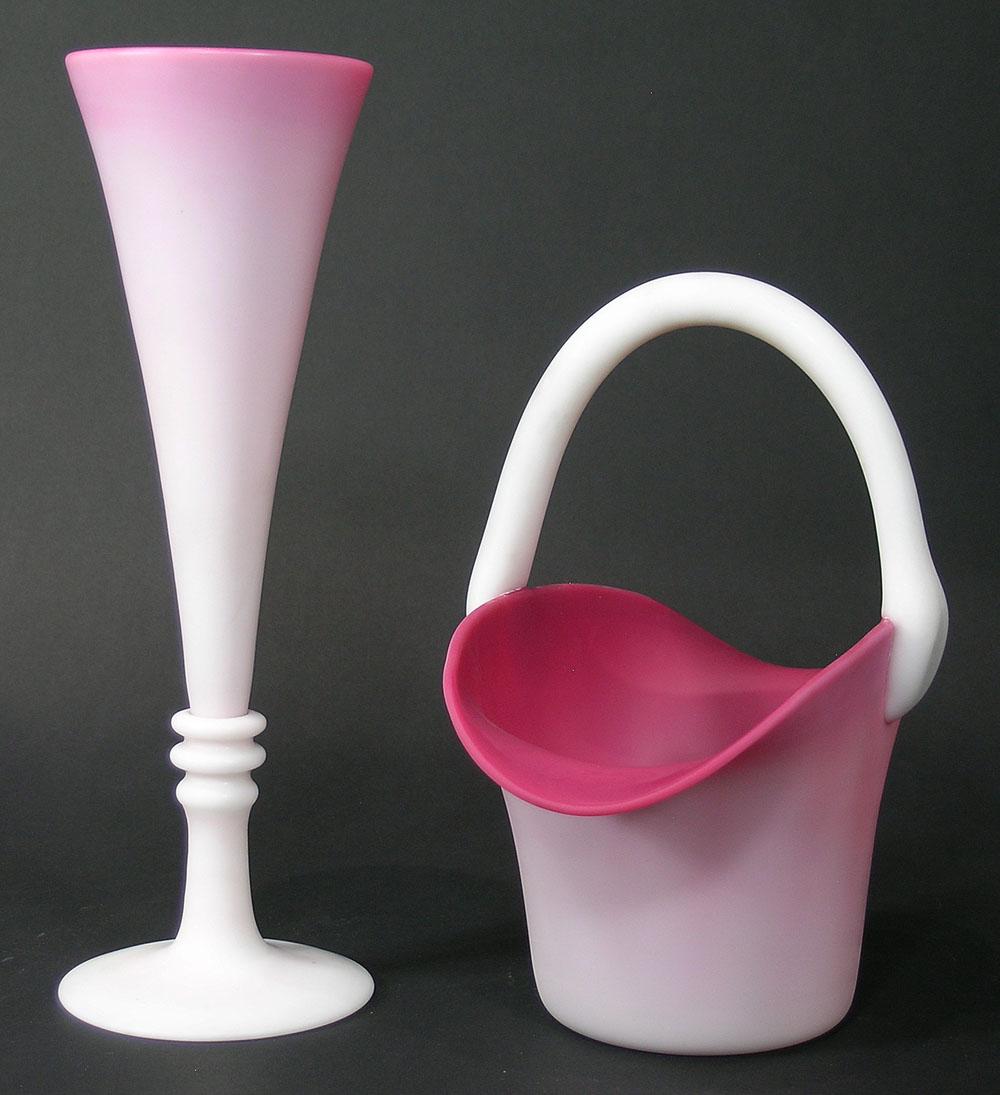 TWO GUNDERSEN PAIRPOINT PEACHBLOW GLASS VASES: a trumpet vase with three rings just above the base, 11 3/4" high, and a basket, 8" long, 6" wide, 9" high, both having polished pontils