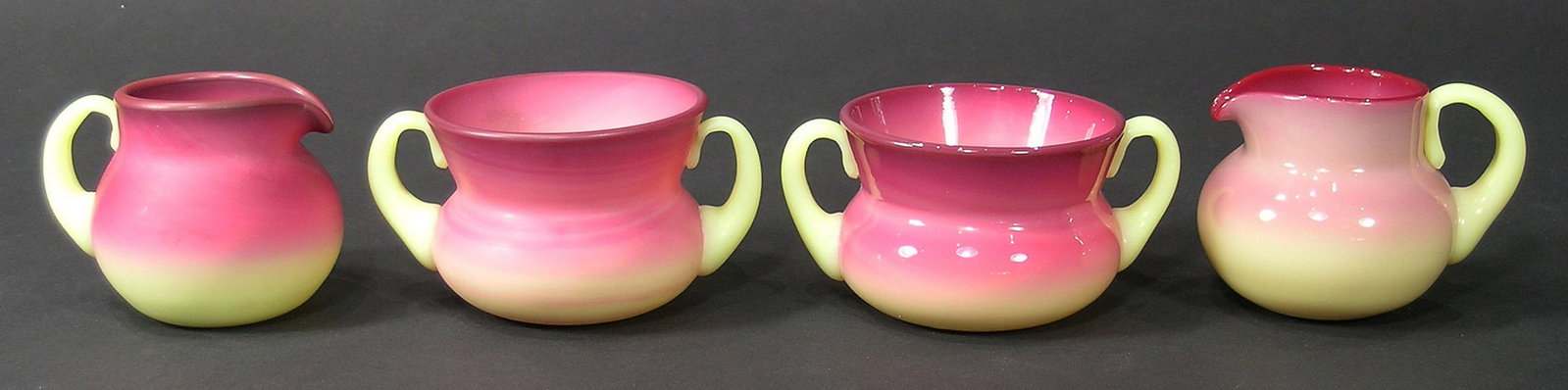 TWO PAIRS OF BURMESE GLASS SUGAR BOWLS AND CREAMERS: one matte finish, one gloss finish, sugar bowls 2 1/4" high, creamers, 2 1/2" high