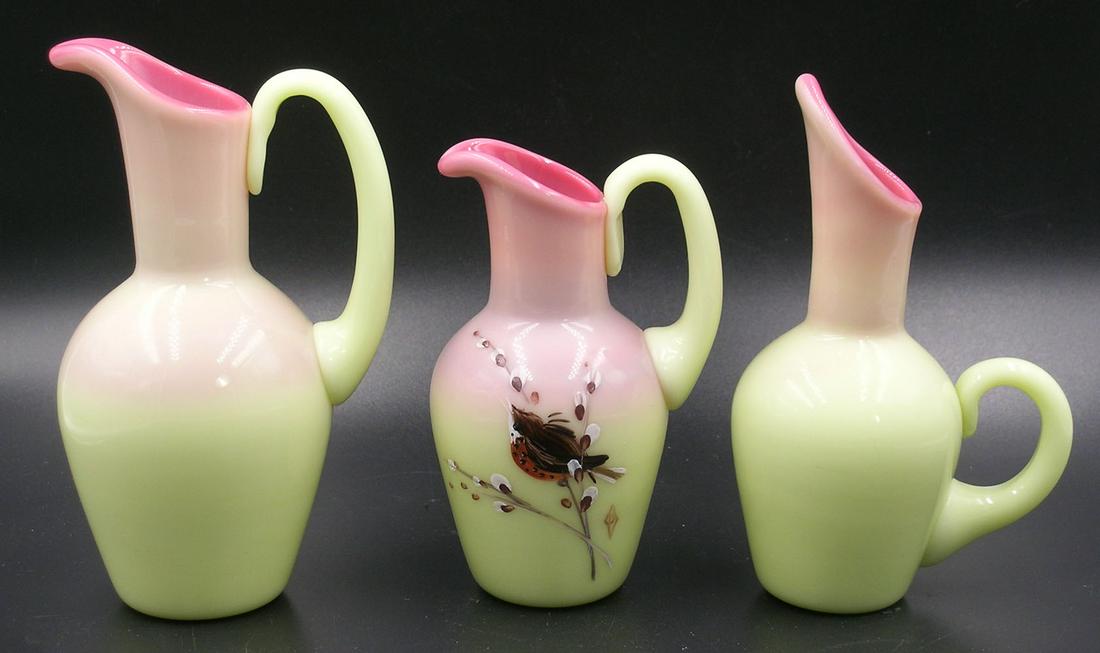 THREE SMALL BURMESE GLASS EWERS: all having gloss finish, one having a hand painted Chickadee on a Pussy Willow Branch, the tallest being 5" high