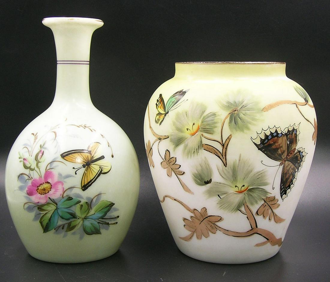 TWO ANTIQUE MILK GLASS VASES: possibly Mt. Washington, both having butterfly and floral decoration, one shouldered tapering form, with painted yellow shoulder, 5 3/4" high, and a bottle form with light green painted body, 7" high