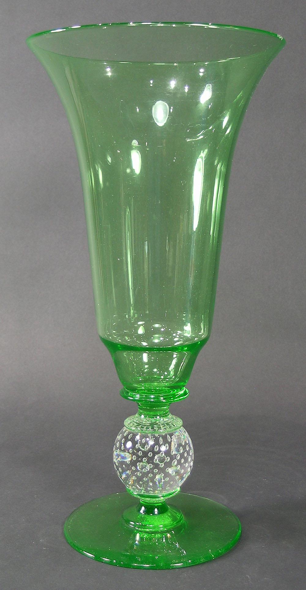 GUNDERSEN MASTERPIECE GLASS VASE: #B-1485, having a Green glass trumpet form vase, over a colorless glass ball standard having controlled air bubbles, over a Green base, polished pontil, 6 3/4" dia., 13" high, having original silver l