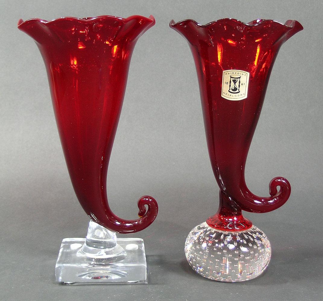 TWO PAIRPOINT RUBY GLASS CORNUCOPIA VASES: both having ruffled rime, one having a colorless glass ball base with controlled air bubbles, and one being a Gundersen Masterpiece having a square colorless glass base, both 8 1/2" high