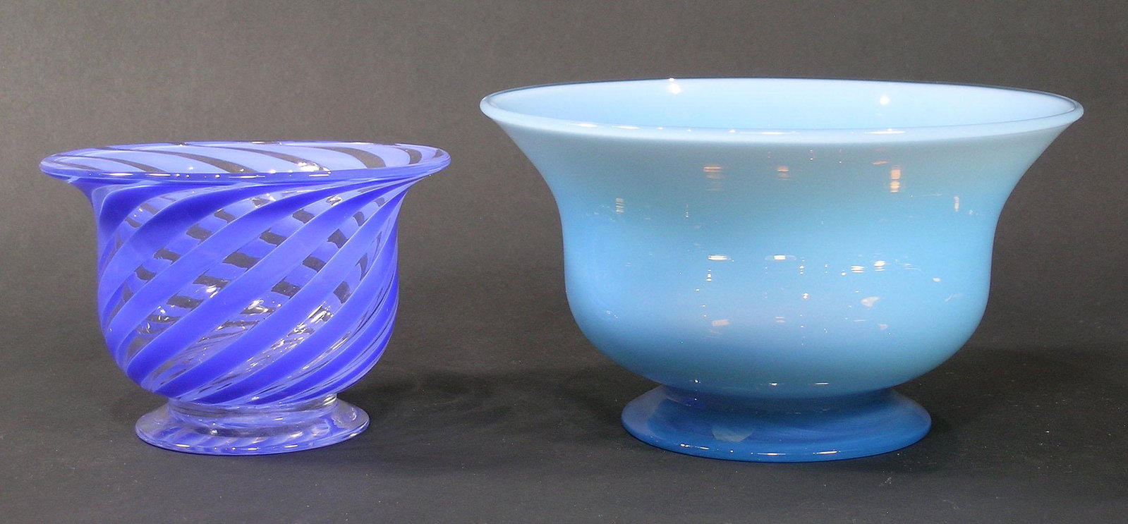 TWO PAIRPOINT GLASS FOOTED BOWLS: one opalescent blue, 7 1/4" dia., 4" high, and one colorless glass with blue swirl, 5" dia., 3 1/2" high, both having unfinished pontils