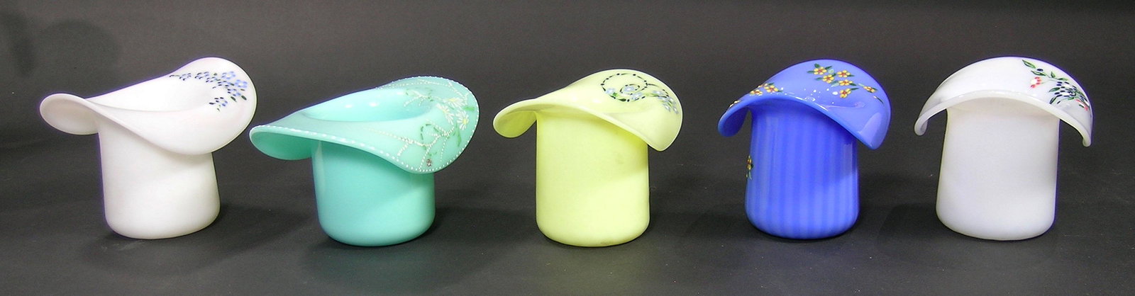 FIVE PAIRPOINT GLASS HATS: various colors, one satin glass, all having hand painted enamel floral, leaf and bead decoration, all being approx. 3 1/4" high