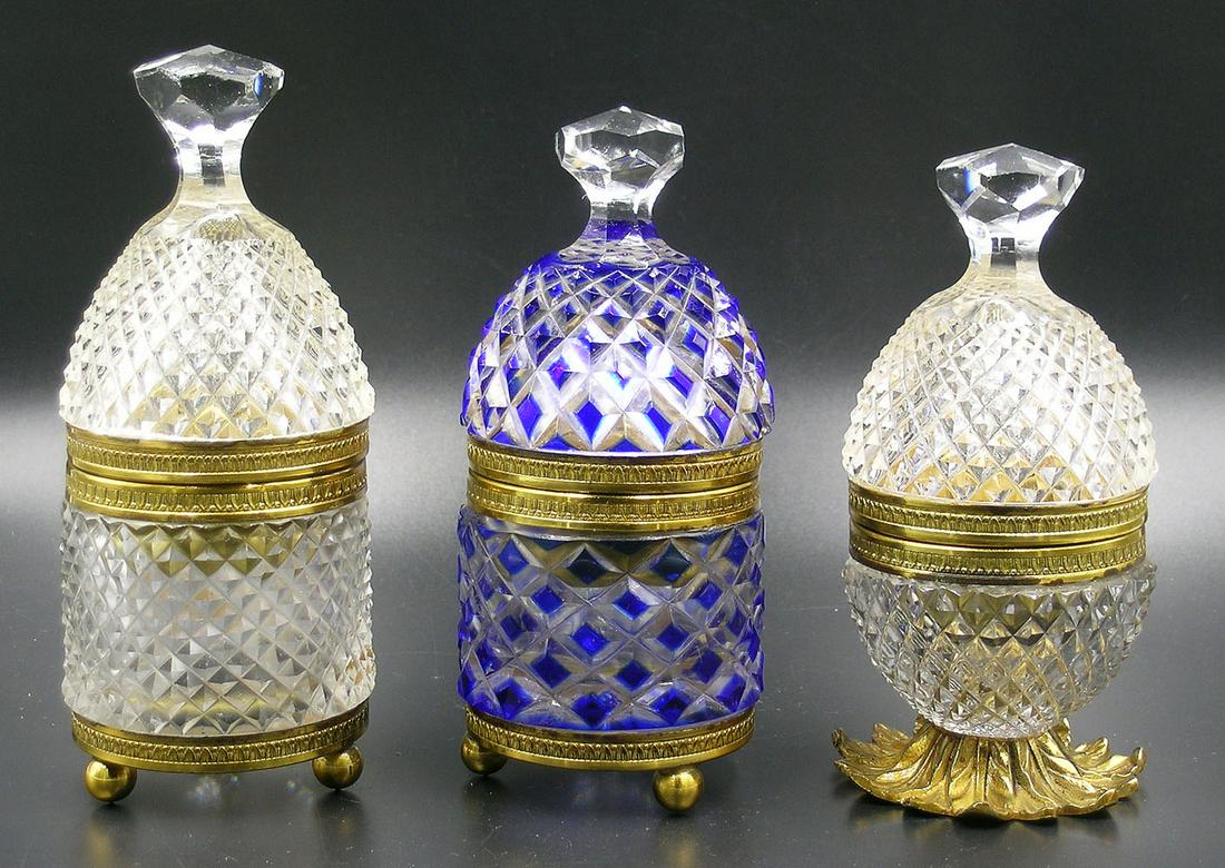 THREE PAIRPOINT SPAIN CUT GLASS FAIRY LAMPS: all having hinged tops and brass fittings, one egg shape having a flaring leaf form base, 5 1/8" high, one being bee hive form, raised on three ball feet, 5 7/8" high, and one bee hive form, cobalt cu