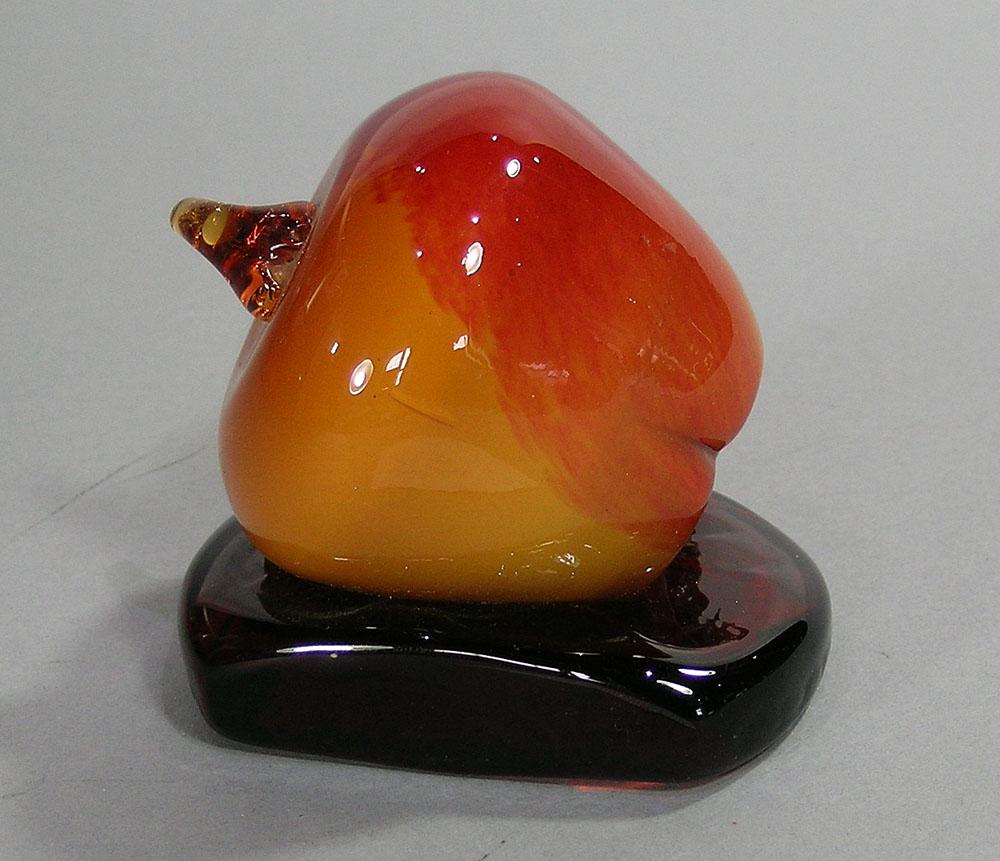 ART GLASS PAPERWEIGHT: in the form of an apple, on an amber glass base, 2 7/8" high