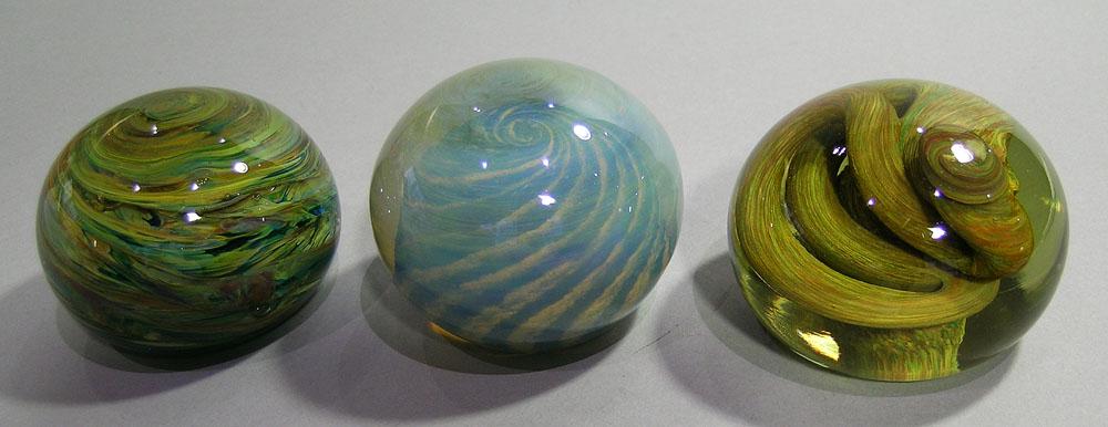 THREE SALAMANDRA ART GLASS SWIRL PAPERWEIGHTS: all are signed, and are dated 10/75, 6/76 and 8/76, the largest is 3" dia.