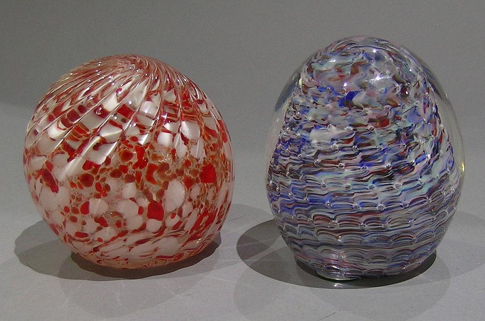 TWO PAIRPOINT ART GLASS PAPERWEIGHTS: one has swirling external glass with paper label, 3 1/4" dia.; one is egg form with internal swirl, 3" dia.