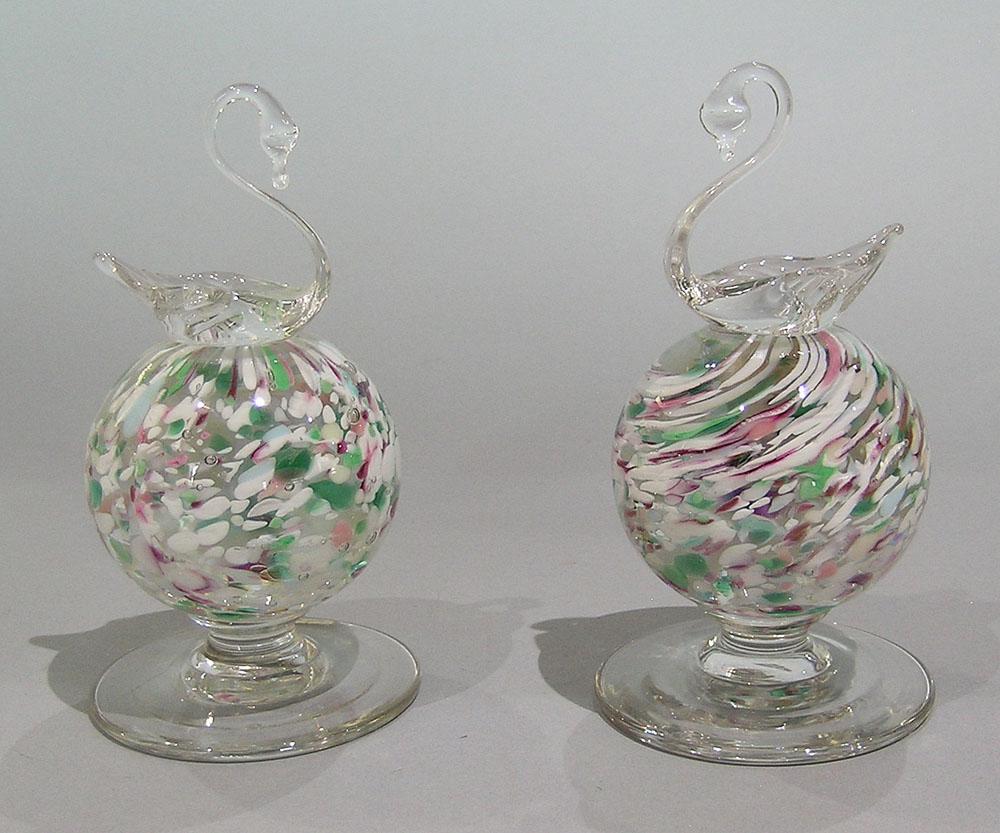 TWO PAIRPOINT ART GLASS PEDESTAL PAPERWEIGHTS WITH: both being spatter ball form weights with swans on top, one having original round paper label, the tallest being 5 3/4" high.