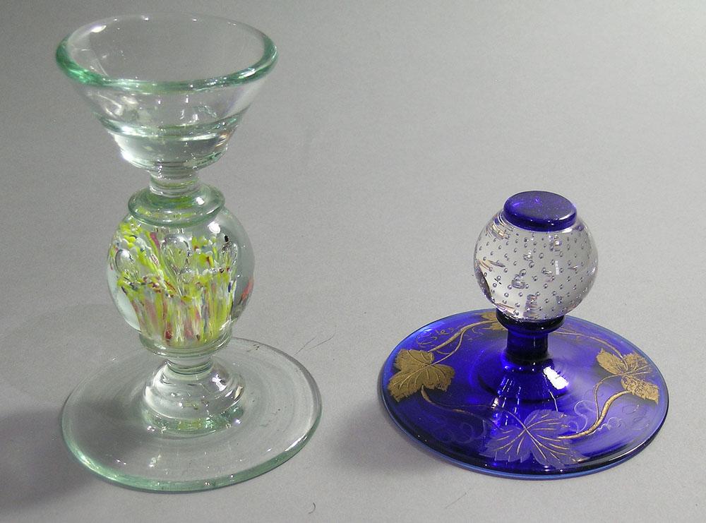 TWO PAIRPOINT ART GLASS PEDESTAL PAPERWEIGHTS: one having entrapped air bubbles on a cobalt glass base having etched and gilt vine decoration, 3" high, and one colorless glass with floral decoration with air bubbles, flaring opening at top, 5 1/2"