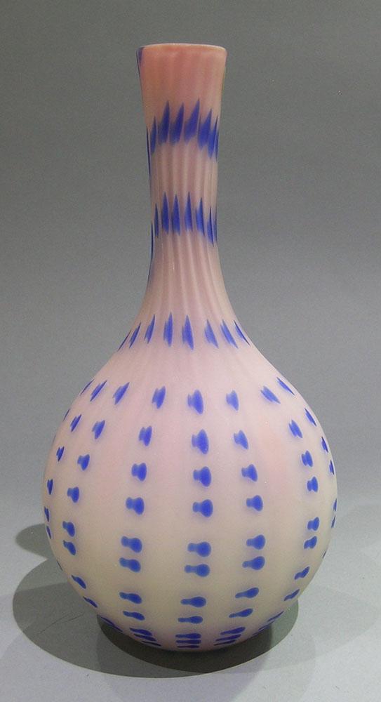 BURMESE SATIN GLASS VASE: Burmese glass, bulbous body with a tapering neck, having vertical ribbing and applied blue dot decoration throughout twisting at tapering neck, semi-polished pontil, 10 5/8" high
